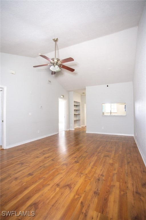 Unfurnished living room featuring wood finished fl