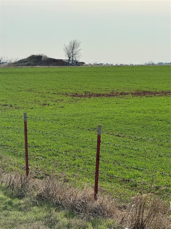 View of yard with a rural view