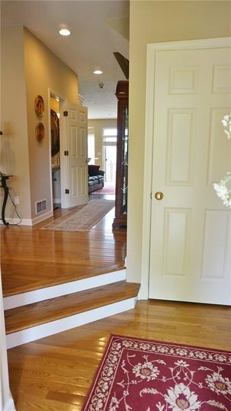 Entry - Hardwood flooring, coat closet.