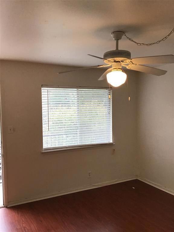 Unfurnished room featuring a ceiling fan, baseboa