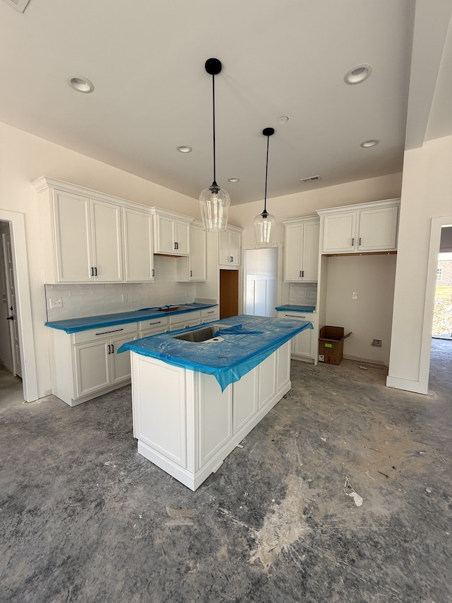 Beautiful kitchen with black hardware and light fixtures. Laminate wood flooring in all areas downstairs excluding bathrooms and laundry.