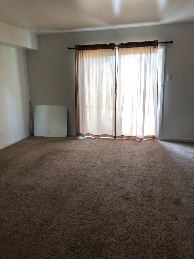 Large living area with sliding door to private pat