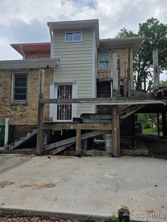 Back of house with brick siding