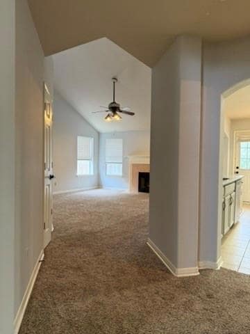 Hall featuring baseboards, arched walkways, vault