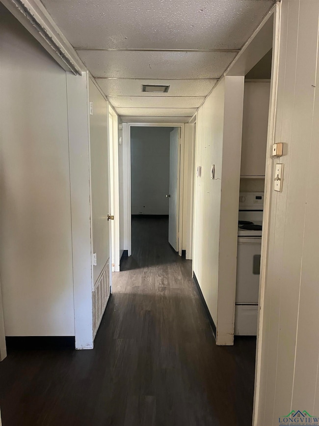 Hallway with dark wood-type flooring