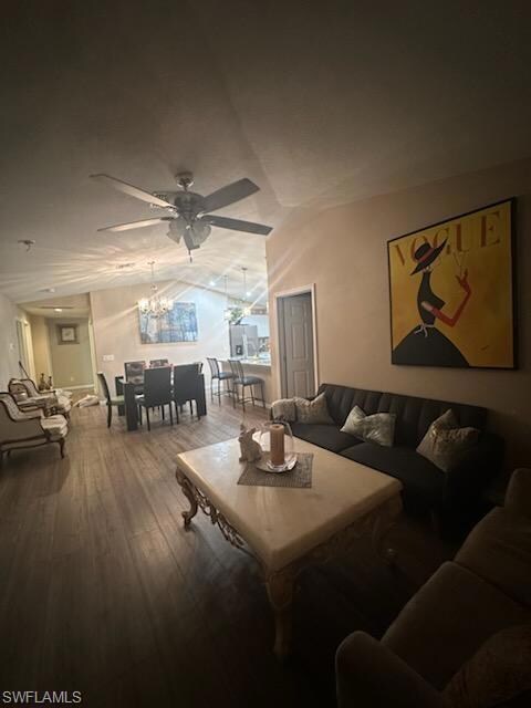 Living room featuring ceiling fan with notable cha