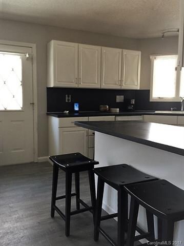 WHITE CABINET KITCHEN W BLACK COUNTERS AND NEW STA