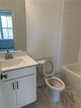 Bathroom featuring vanity and washtub / shower combination