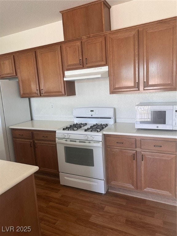 Kitchen with dark wood finished floors, extractor
