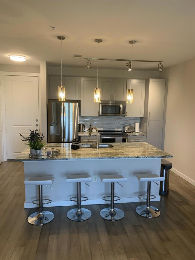 Kitchen featuring stainless steel appliances, dar