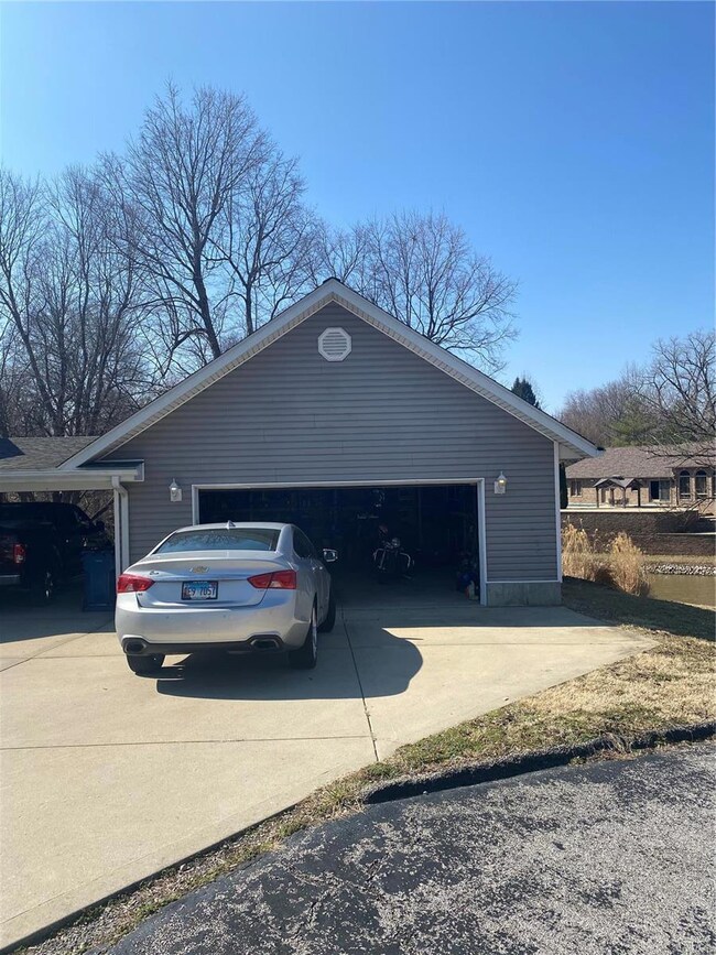 30x24 garage with generous amounts of wooded shelving and above rafter storage. Comes with ample electrical outlets.