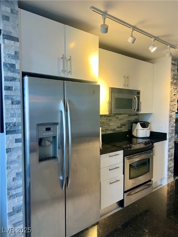 Kitchen featuring stainless steel appliances, rail