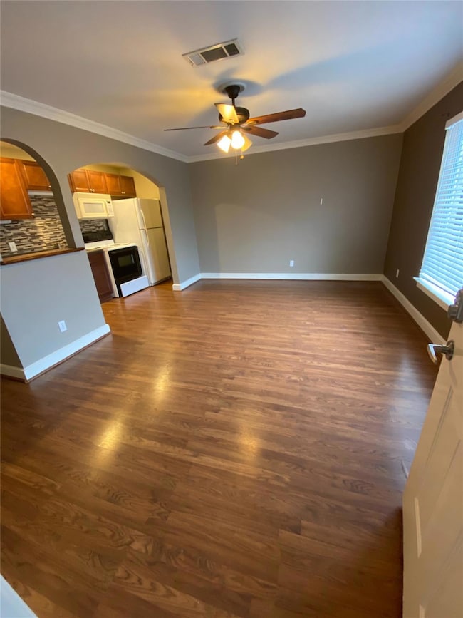 Unfurnished living room featuring visible vents, d