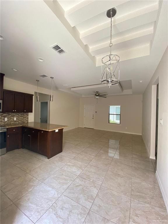 Kitchen with open floor plan, a ceiling fan, dark brown cabinets, backsplash, and pendant lighting