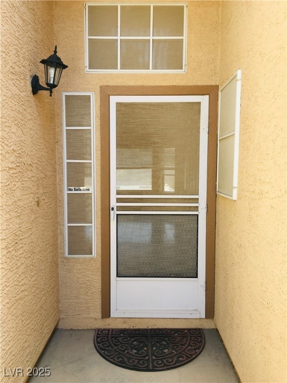 Property entrance with stucco siding