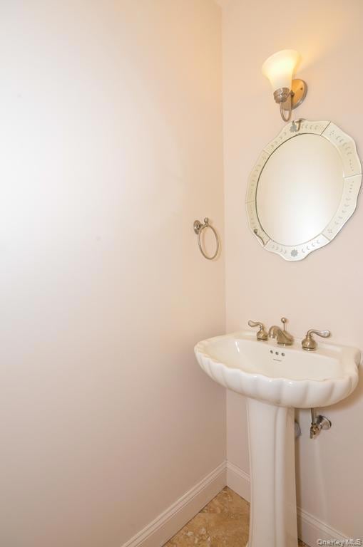 Bathroom featuring light tile patterned floors and baseboards