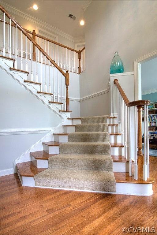 Grand 2-story foyer with hardwood floors, chair ra