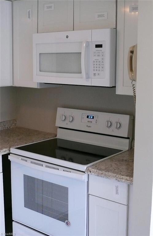 Kitchen -- New cabinets, appliances, floor, and countertops.