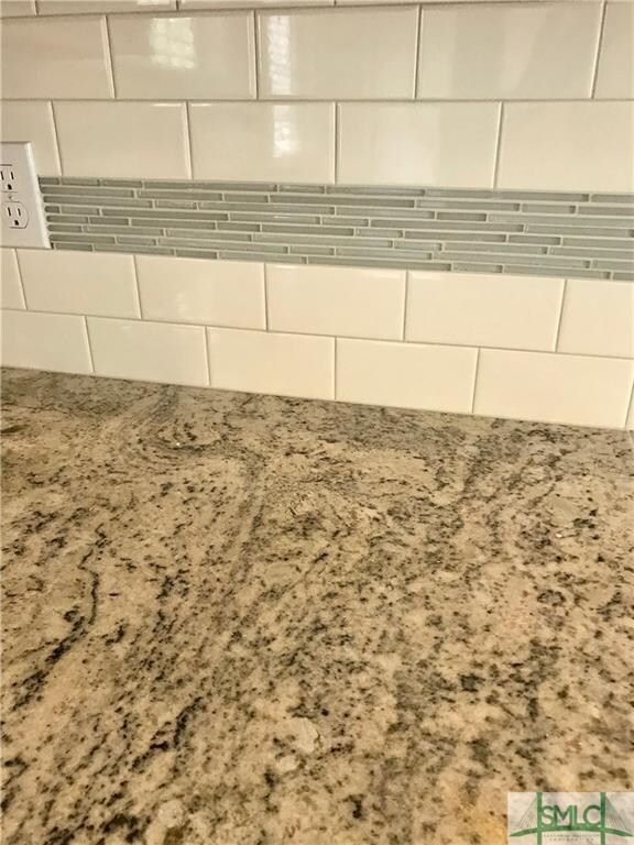 Detail of granite kitchen counters and tiled backs