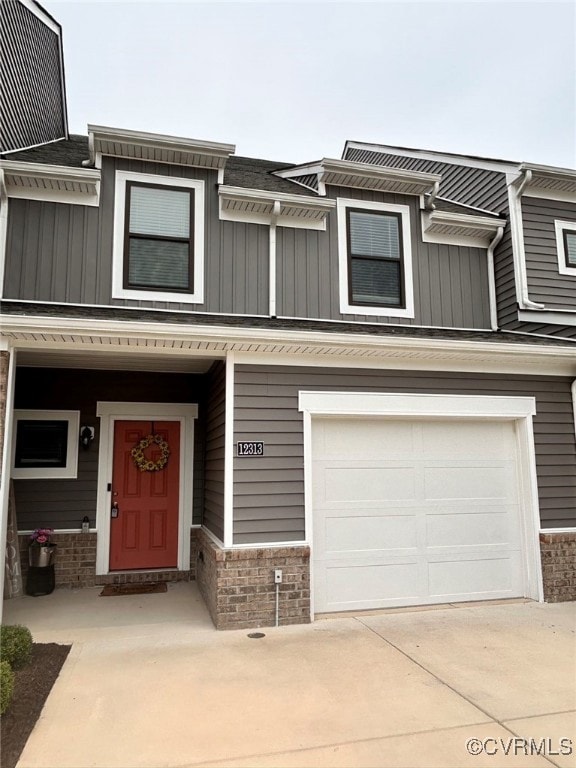 View of property featuring brick siding, board and