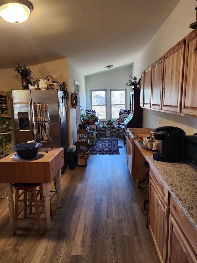 Large eat in kitchen with new flooring, beautiful new cabinets and new granite countertops.
