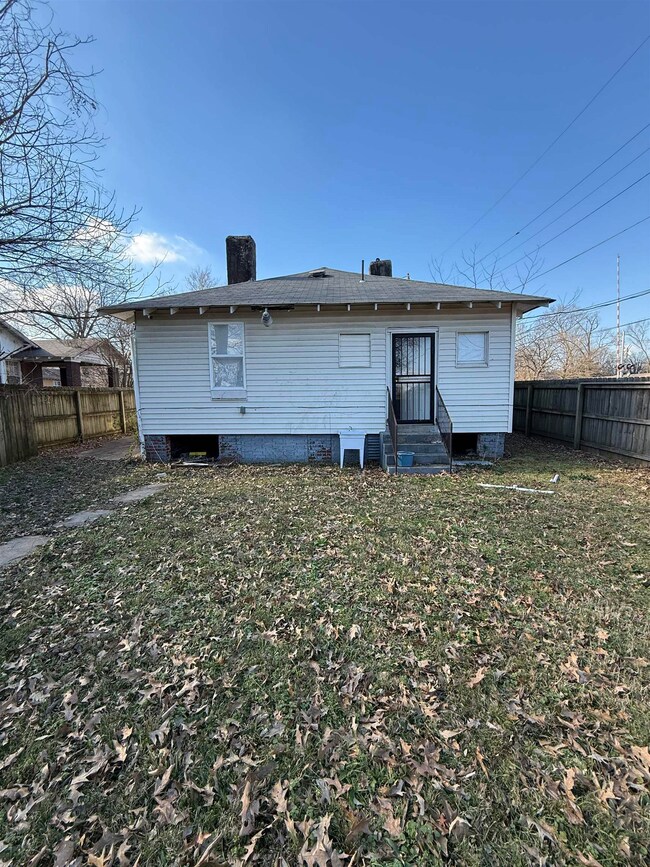 Back of house featuring a lawn