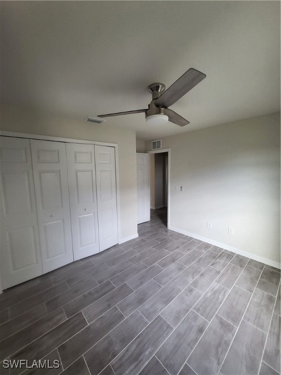 Unfurnished bedroom featuring a closet, wood finis