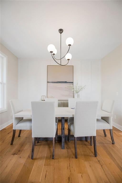 Dining area featuring a chandelier and wood finished floors