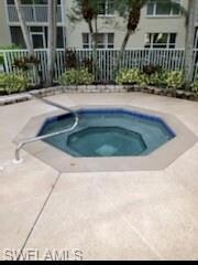 View of swimming pool featuring an in ground hot t