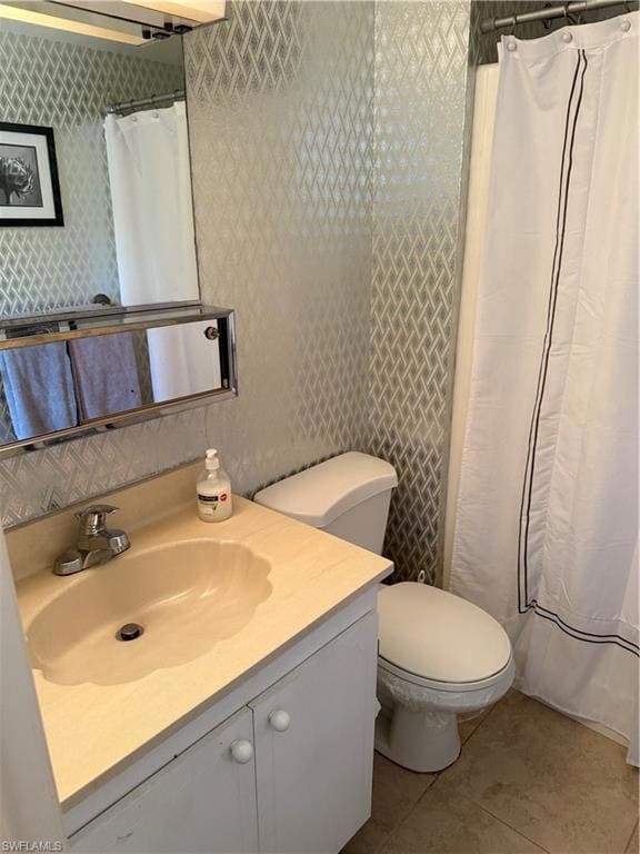 Bathroom with vanity, tile patterned flooring, and curtained shower