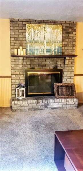 Log Burning Fireplace in Family Room View from Kit