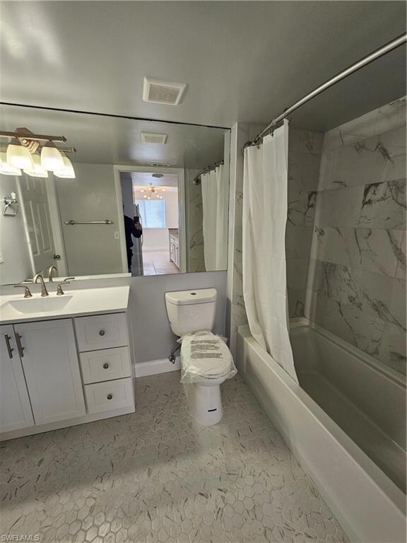 Full bathroom featuring shower / tub combo with curtain and vanity