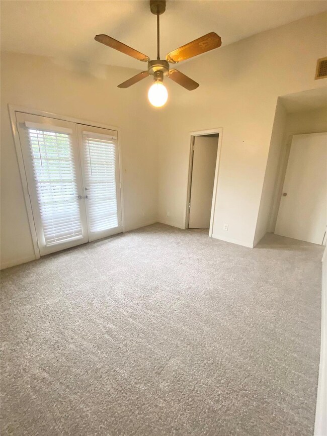 Empty room featuring light colored carpet, visibl