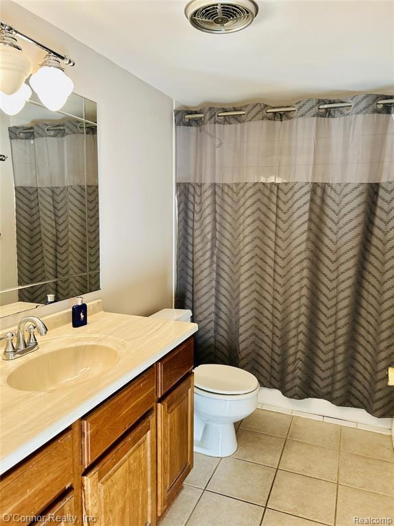 Bathroom with light tile patterned floors and vanity