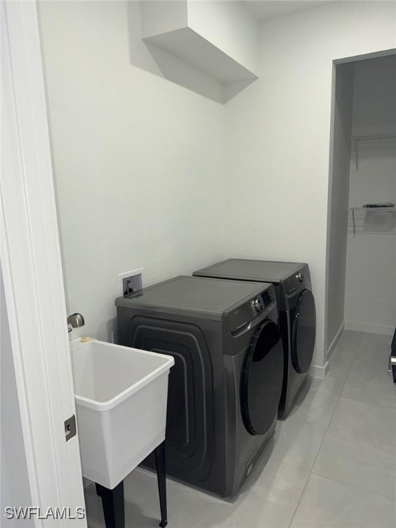 Washroom featuring a sink, washer and clothes drye