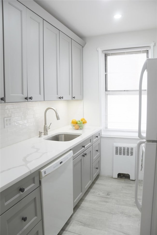 Kitchen with quartz countertops, backsplash and soft close cabinets.