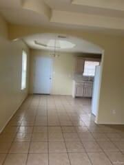Spare room featuring a raised ceiling and light tile patterned floors