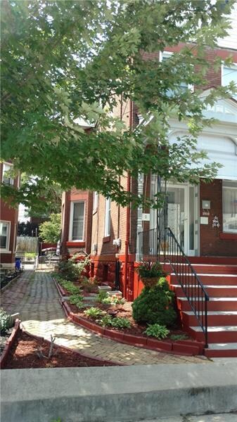 Landscaped walkway to the rear of the home