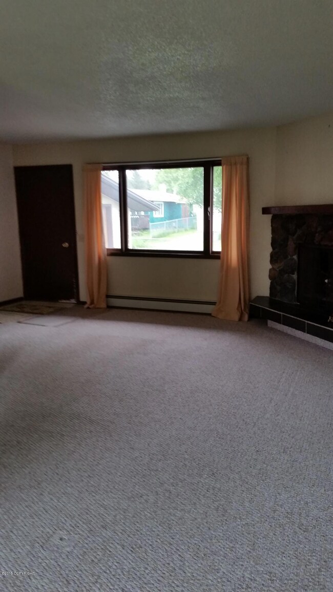 living room with wood burning fireplace