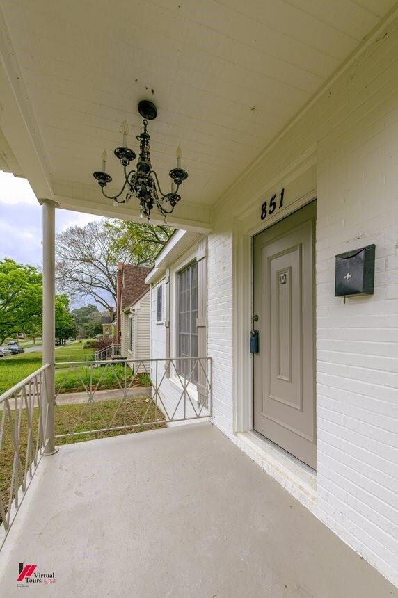 Doorway to property with covered porch