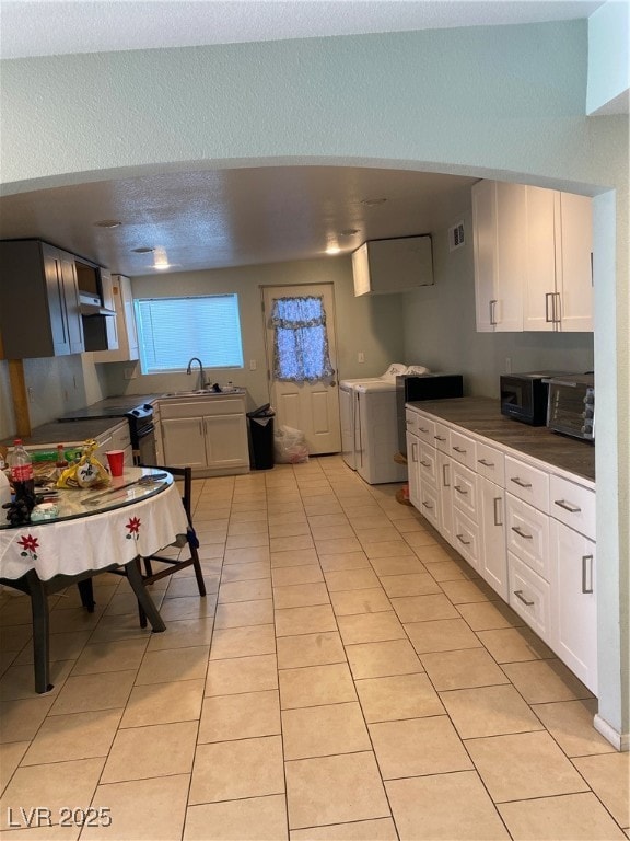 Kitchen featuring white cabinets, visible vents, w