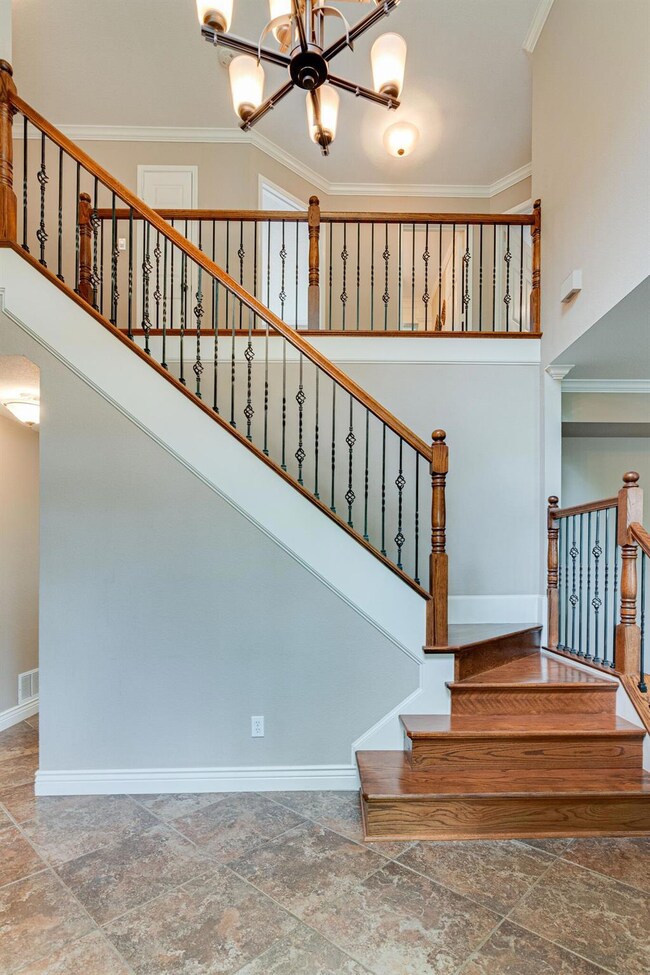 Beautiful foyer with winding staircase to the seco