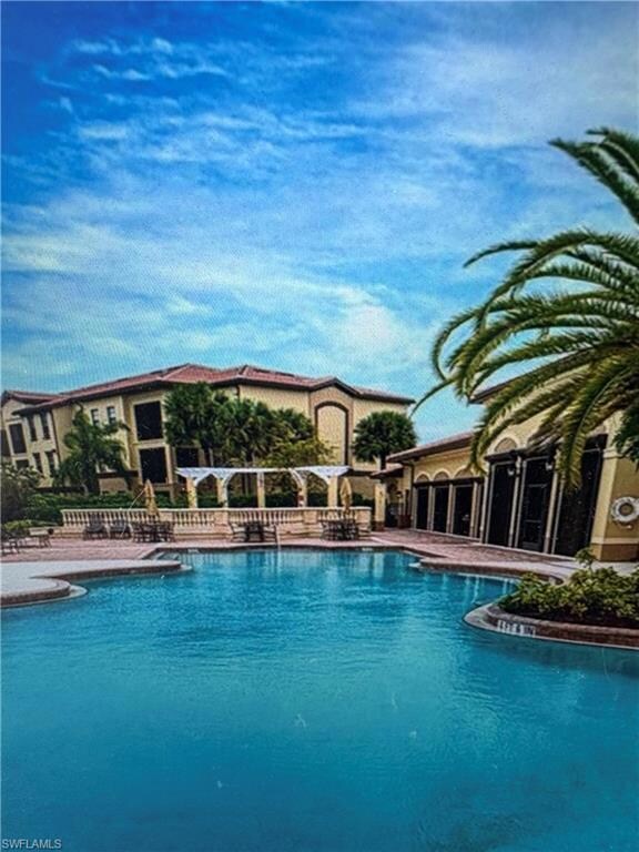 Community pool featuring a patio