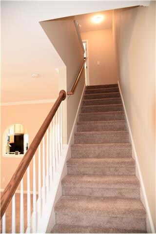 New carpet throughout.  Stairs lead to two bedrooms and full bath up