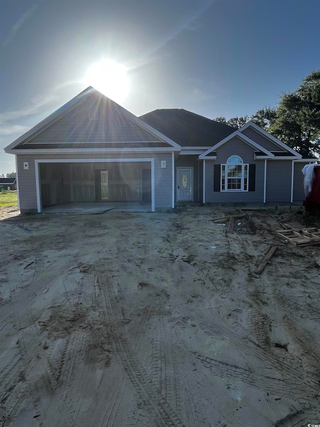 View of front of home featuring an attached garage and driveway