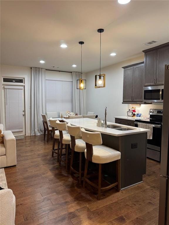 Kitchen with pendant lighting, an island with sink