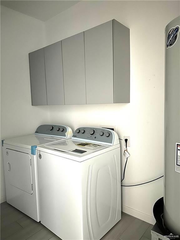 Washroom with independent washer and dryer, water heater, and cabinet space