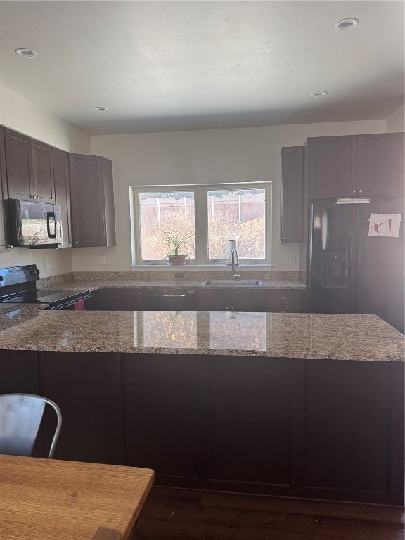 Kitchen featuring light stone countertops, sink, a
