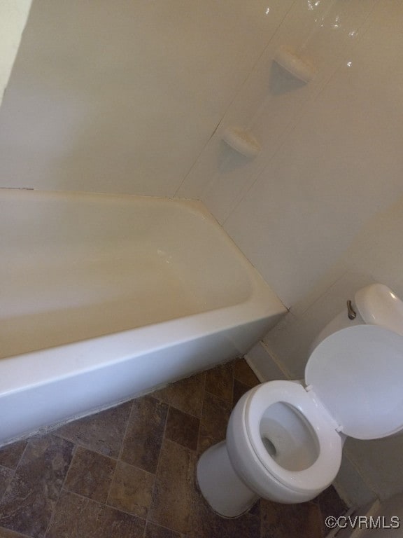 Full bath featuring toilet and a bath