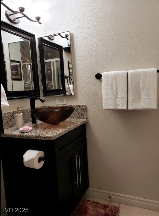 Bathroom featuring vanity, tile patterned flooring